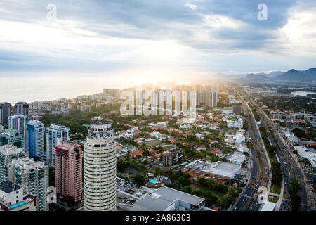 Sunlight breaking through clouds over cityscape of Rio de Janeiro Stock Photo