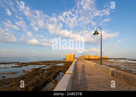 Paseo Fernando Quinones leading to the Castillo de san sebastian at low tide in the early morning, Cadiz, Andalucia, Spain, Europe Stock Photo