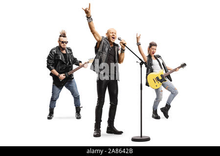 Full length portrait of a male rock star singing on a microphone and male and female musicians playing guitars isolated on white background Stock Photo