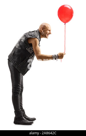 Full length shot of a bald man in leather clothes giving a red balloon isolated on white background Stock Photo