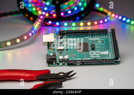 Arduino Mega2560 displayed with LED strip and wire cutters. Stock Photo