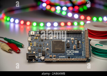 Arduino Due displayed with alligator clip leads, LED strip, and hookup wire. Stock Photo