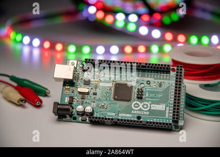 Arduino Mega2560 displayed with LED strip, hookup wire, and alligator clip jumpers. Stock Photo