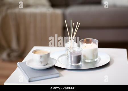 coffee, candles and aroma reed diffuser on table Stock Photo