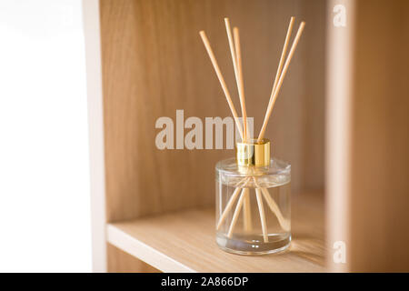 aroma reed diffuser on wooden shelf Stock Photo
