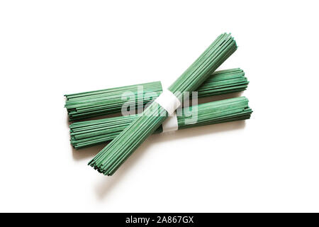 Raw vegan noodles soba with spirulina isolated on white background. Traditional Japanese food. Top view. Stock Photo