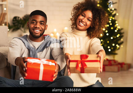 Happy New Year! Happy afro couple holding xmas gifts Stock Photo
