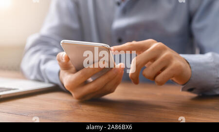 Unrecognizable man using smartphone checking his money balance Stock Photo