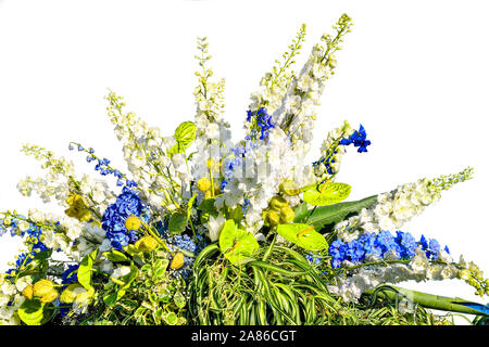 Beautiful floral composition from white and blue flowers and variegated leaves of decorative plants. Gorgeous bouquet from different flowers and plant Stock Photo