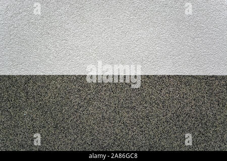 Fragment of a textured wall with light and dark areas for use as an abstract background. Stock Photo