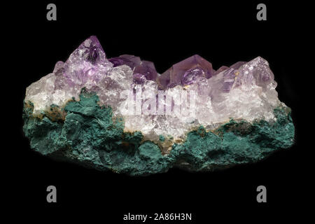 Rock of natural violet amethyst mineral from Brazil isolated on a pure black background. Stock Photo