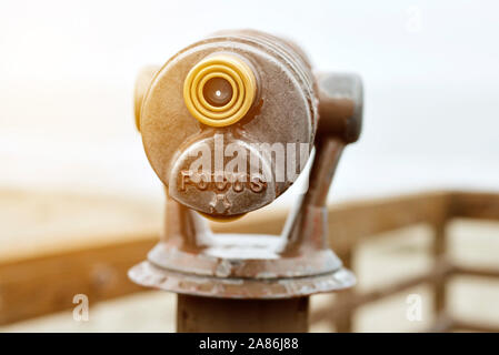 Beach telescope for tourists with the words Focus and warm lighting Stock Photo