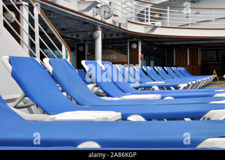 Deck chairs lined up on the deck of the Crown Princess Cruise Ship Stock Photo