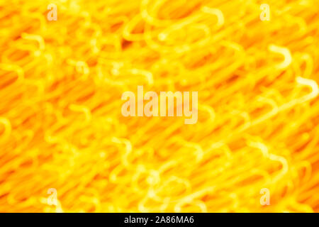 Futuristic blurred lights holiday monochrome background in yellow. Horizontal, soft focus Stock Photo