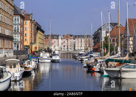 COPENHAGEN, DENMARK - 23RD MAY 2017: Boats docked along the Christianshavn canals in Copenhagen during the day. Reflections can be seen. Stock Photo