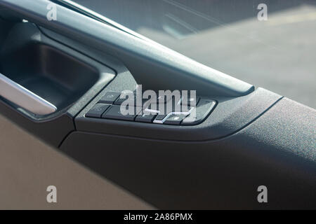 Car door handle with control buttons closeup Stock Photo
