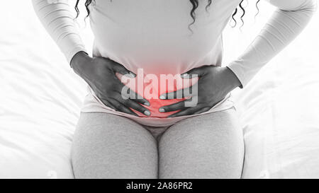 Black and white picture of woman suffering from stomach ache Stock Photo
