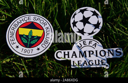 September 6, 2019 Istanbul, Turkey. The emblem of the Turkish football club Fenerbahce Istanbul next to the logo of the Champions League on the green Stock Photo