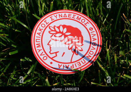 September 6, 2019 Istanbul, Turkey. The emblem of the Greek football club Olympiacos Piraeus  on the green grass of the football field. Stock Photo