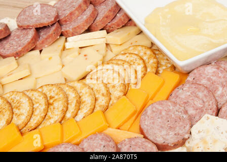Meat and Cheese platter including stone wheat crackers, wheat crackers, summer sausage, cheddar cheese, pepper jack cheese and a mustard sauce. Select Stock Photo