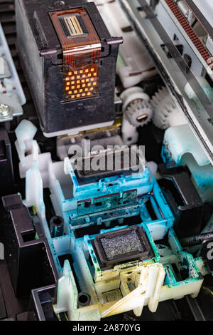 A place to dock ink cartridges. Dirty old home printer. Place - workshop. Stock Photo