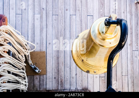 Golden bronze bell on the deck of a sailboat. Stock Photo