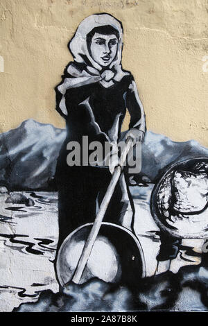 A mural based on a famous old photograph of a female dulang washer, or tin panner, in the Old Town of Ipoh, Perak, Malaysia Stock Photo