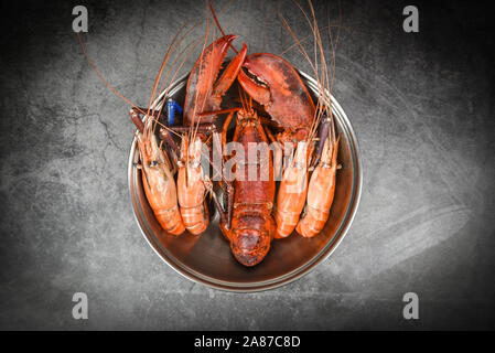 Seafood shellfish with steaming shrimps prawns boiled in hot pot / Lobster food Stock Photo