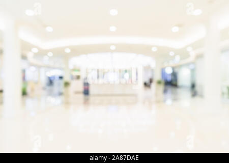 Abstract Blur white modern hall interior with bright light bokeh, office blurred for any business background or backdrop Stock Photo