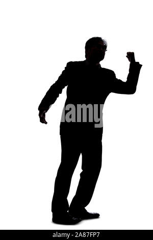 Silhouette of a backlit model posing as a businessman on a white background.  He is punching out of anger with his fists. Stock Photo