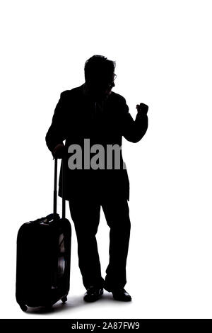 Silhouette of a backlit model posing as a businessman on a white background.  He is gesturing like he is happy or winning Stock Photo