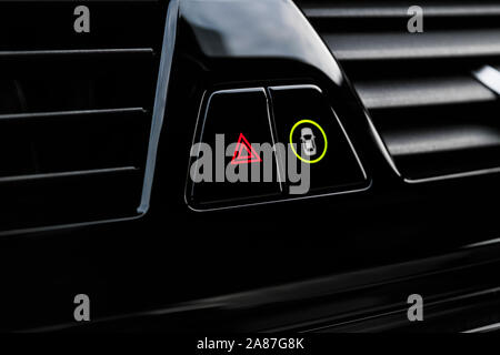Car hazard warning flashers and emergency button with visible red triangle. Selective focus. Automotive part concept. Emergency stop button of the car Stock Photo