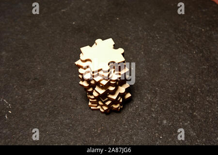 Stack of Puzzle Pieces on black textured background Stock Photo