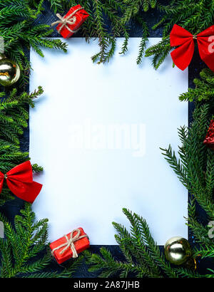 Empty Blank Card Surrounded by Christmas Tree Branches and Christmas Decoration. Simple Christmas Composition Stock Photo