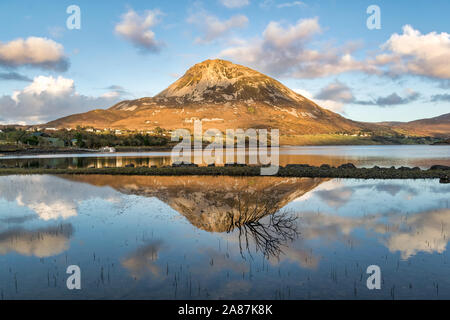 Errigal Mountain in Donegal Ireland being reflected in a lake in front of the mountain