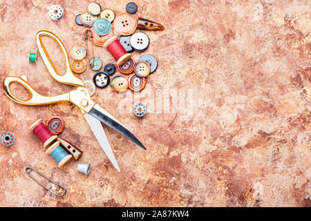 Sewing tools, scissors, many buttons and threads Stock Photo