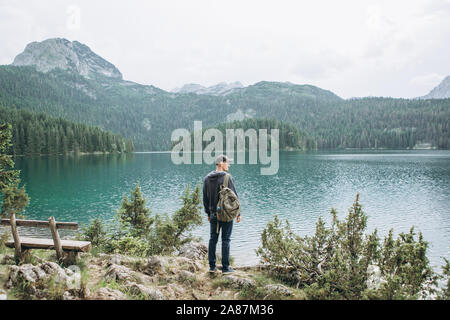 Tourist or traveler near the Black Lake in Montenegro. One of the natural attractions of the country. Stock Photo