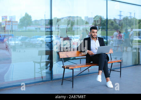 Cool guy arabic man uses laptop business center Stock Photo