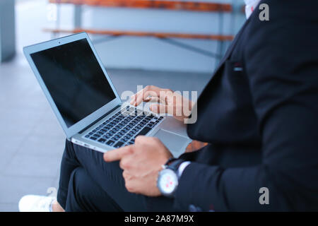 Cool guy arabic man uses laptop business center Stock Photo