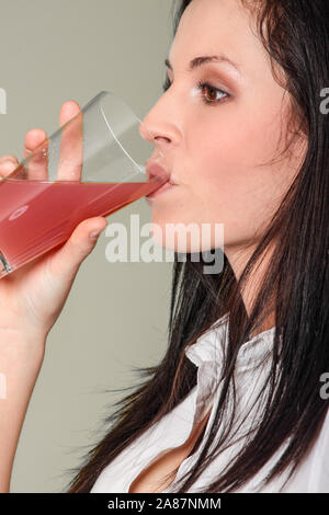 Woman drinking vitamin mineral supplement effervescent tablet dissolved in water. Stock Photo