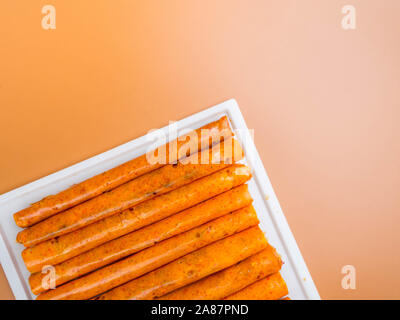Delicious traditional russian healthy sugar free fruit roll-ups made from orange fruits Roll paste on pan Stock Photo