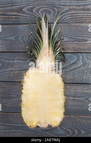 Flat lay of pineapple cut in half. White wooden table. Top view, overhead Stock Photo