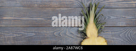 Flat lay of pineapple cut in half. White wooden table. Top view, overhead Stock Photo