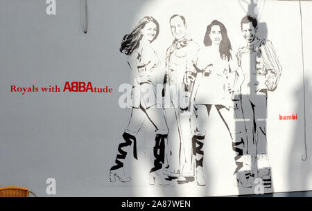 Photo Must Be Credited ©Alpha Press 066465 05/11/2019 British street artist Bambi has created a new mural to celebrate the recently held Royal Wedding of Prince Harry and Meghan Markle, as well as the highly anticipated return of ABBA in Primrose Hill, London. The Royals with ABBAtude mural is a representation of the British Royals as members of Swedish band ABBA, with Kate Catherine Katherine Duchess of Cambridge Middleton reimagined as Agnetha Fsltskog, Prince William as Bjorn Ulvaeus, Prince Harry as Benny Andersson, and Meghan Markle as Anni-Frid Lyngstad. Stock Photo