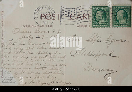 Vintage Post card with one cent green stamp, dress and writing in Norwegian, postage stamped in Ocean Grove N.J. in 19111 Stock Photo