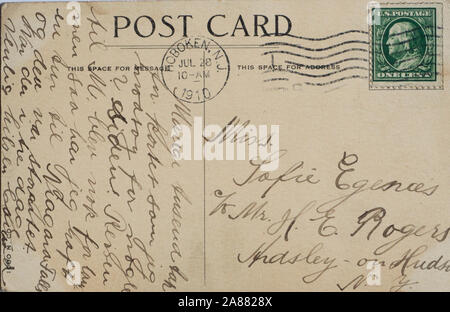 Vintage Post card with one cent green stamp, dress and writing in Norwegian, postage stamped in Hoboken in 1910 Stock Photo