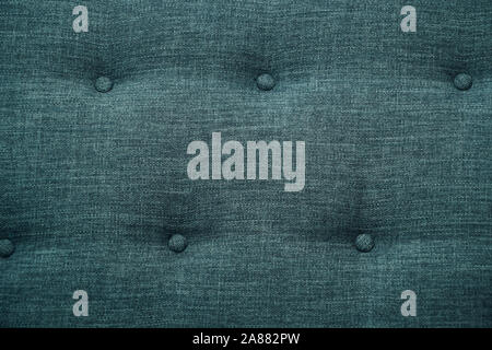 Blue fabric sofa, close up detail with buttons. Furniture showroom photography Stock Photo
