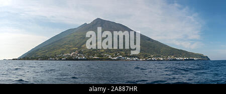 The active stromboli vulcano north east inhabited side, day shot, blue cloudy sky background, panoramic shot, eolians islands, sicily, italy. Stock Photo