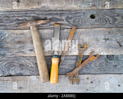 Old rusty vintage tools on weathered grey background Stock Photo