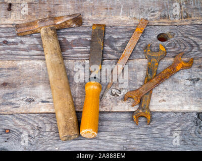 Old rusty vintage tools on weathered background Stock Photo